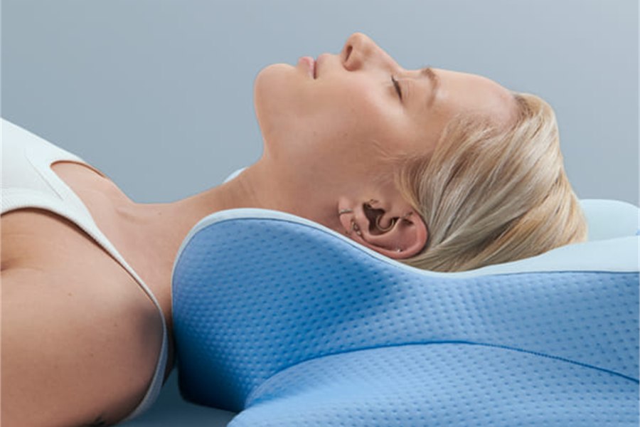 The ergonomic pillow cradling the head and neck of a back sleeper
